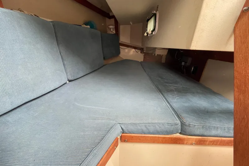 Slide: The Image of Interior cabin of a 1989 Catalina 30 sailboat with blue cushions. - 15
