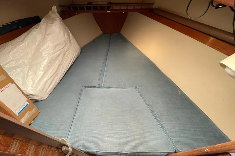 Slide: The Image of Interior cabin of a 1989 Catalina 30 sailboat with blue cushions. - 17