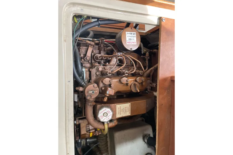 Slide: The Image of Engine compartment of a 1989 Catalina 30 sailboat, showcasing mechanical components. - 20