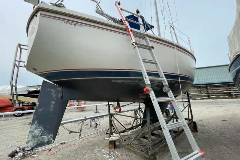 Slide: The Image of 1989 Catalina 30 sailboat on dry dock with ladder for maintenance. - 3