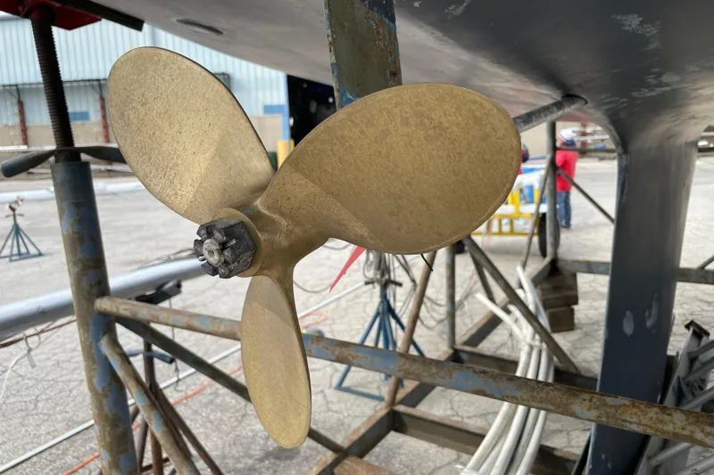 Slide: The Image of Close-up of a Catalina 30 sailboat propeller, 1989 model, in a shipyard setting. - 5