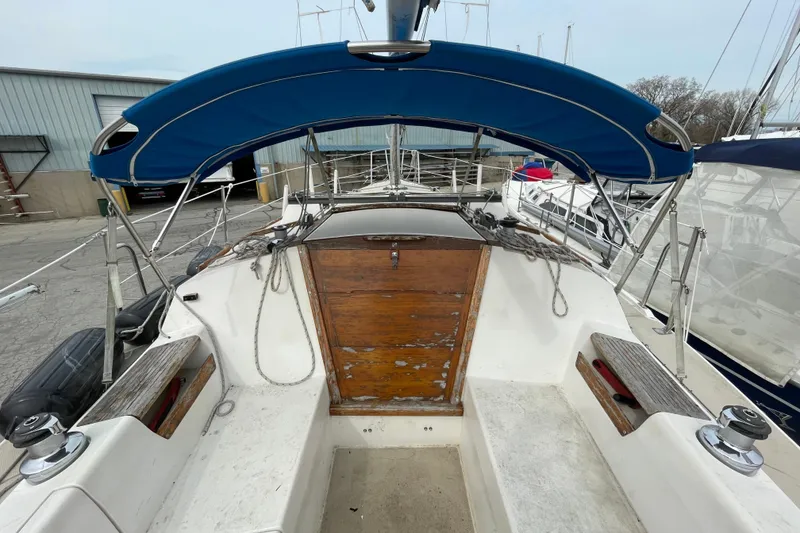 Slide: The Image of 1989 Catalina 30 sailboat cockpit with blue canopy and wooden hatch. - 6