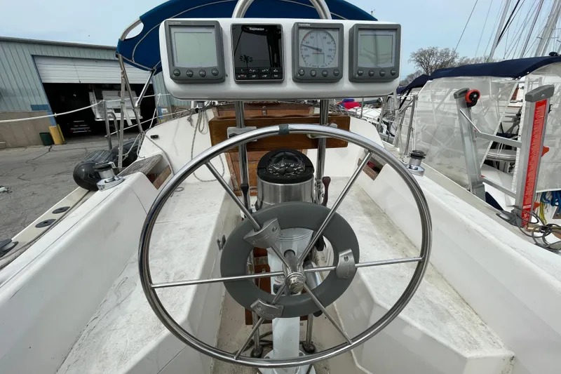 Slide: The Image of Cockpit of 1989 Catalina 30 sailboat with steering wheel and navigation instruments. - 7