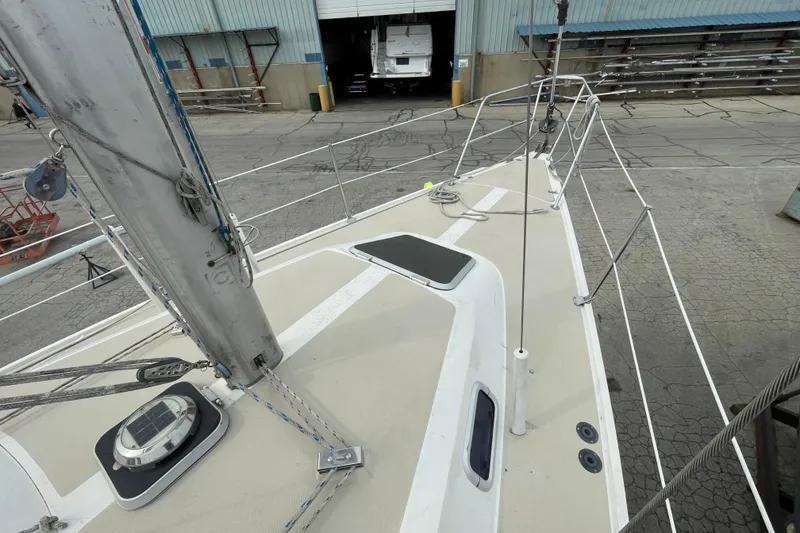 Slide: The Image of 1989 Catalina 30 sailboat deck view in a shipyard setting. - 9