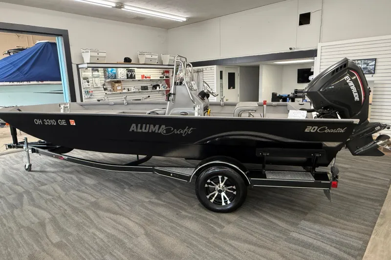 The Image of 2020 Alumacraft 20 Bay boat with Evinrude motor displayed indoors. - 17