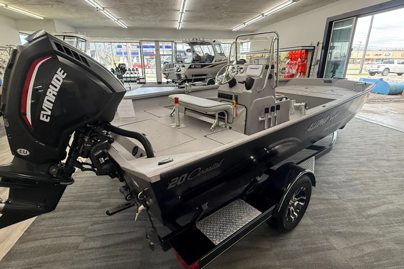 Slide: The Image of 2020 Alumacraft 20 Bay boat with Evinrude motor displayed indoors. - 21