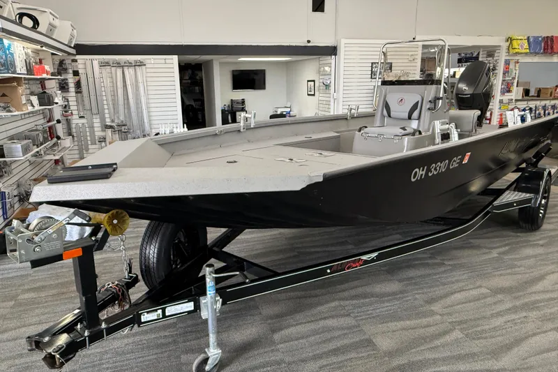 Slide: The Image of 2020 Alumacraft 20 Bay boat on trailer in showroom, featuring sleek design and modern equipment. - 27