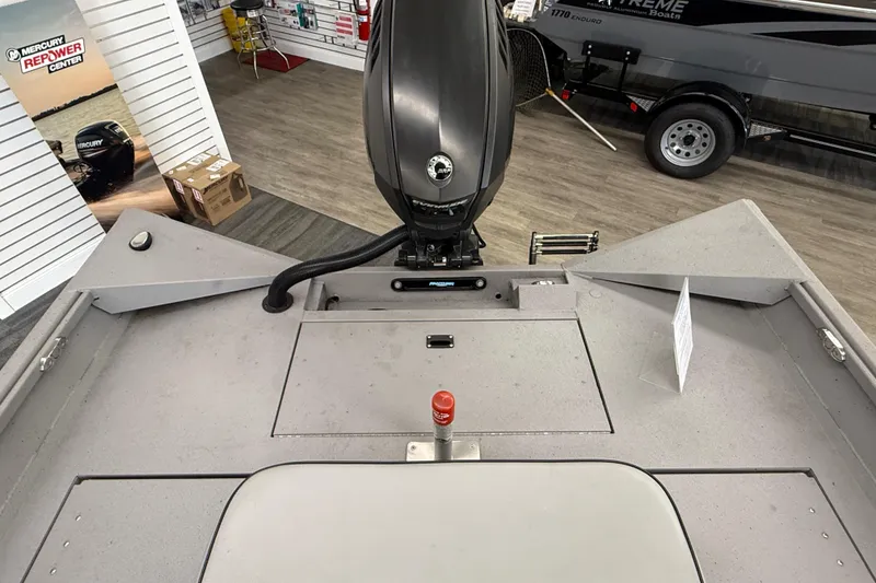 Slide: The Image of 2020 Alumacraft 20 Bay boat interior with Mercury engine in showroom setting. - 30