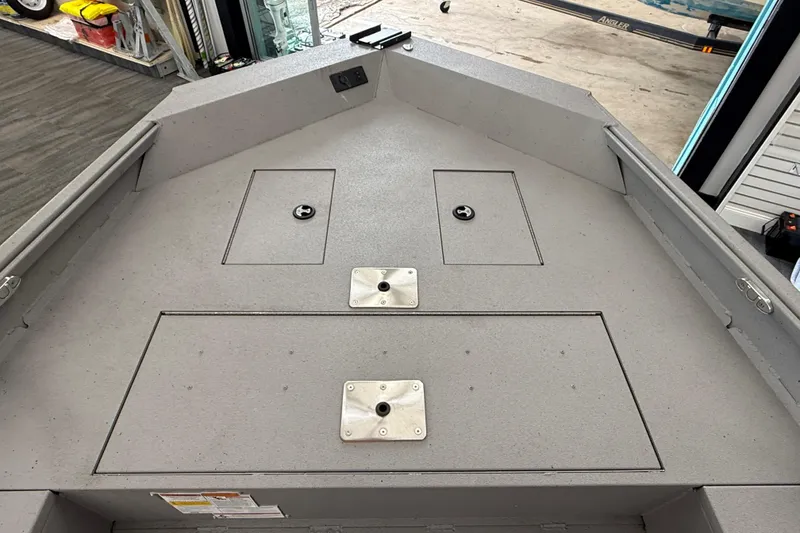 Slide: The Image of 2020 Alumacraft 20 Bay boat deck with storage compartments and mounting plates. - 33