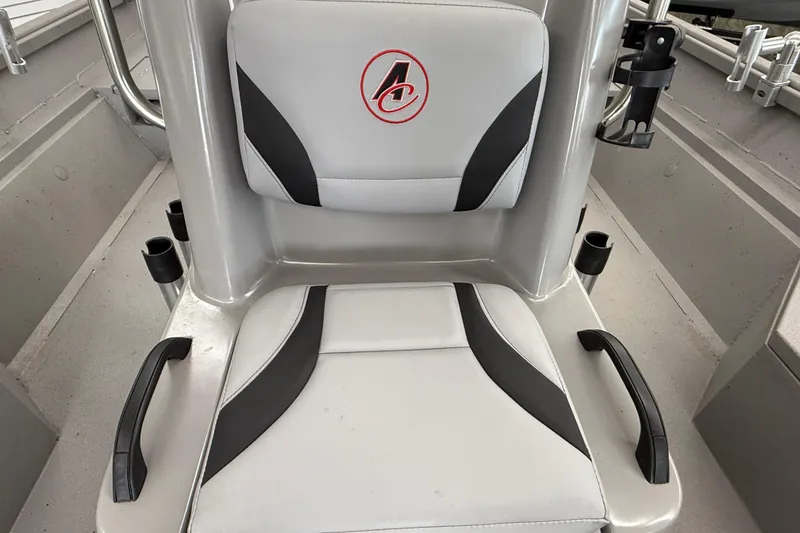 Slide: The Image of 2020 Alumacraft 20 Bay boat seat with logo, featuring cup holders and handles. - 35