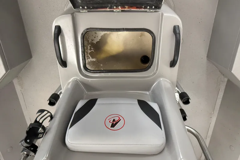 Slide: The Image of 2020 Alumacraft 20 Bay boat interior with cushioned seat and storage compartment. - 40