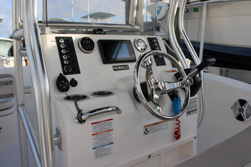 Slide: The Image of 2017 Robalo R200 Center Console boat dashboard with steering wheel and controls. - 10