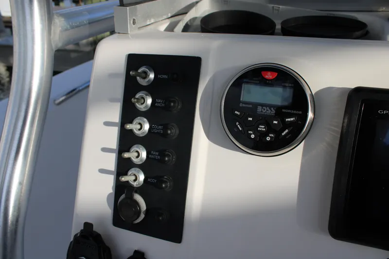 Slide: The Image of Control panel of a 2017 Robalo R200 Center Console boat with switches and audio system. - 12