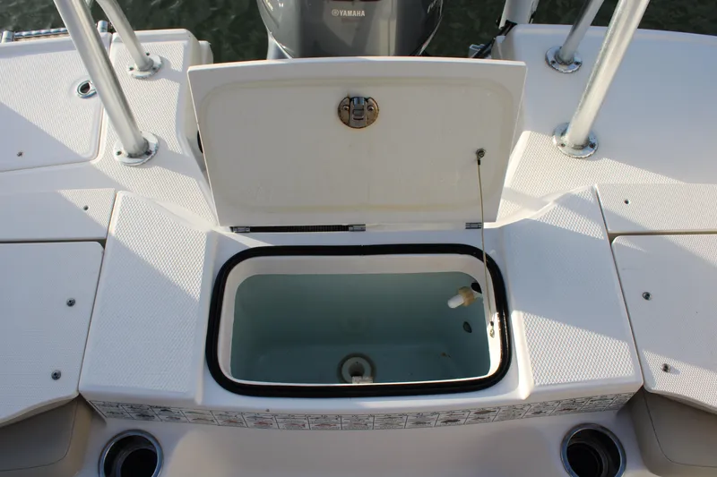 Slide: The Image of 2017 Robalo R200 Center Console boat with open storage compartment and Yamaha engine. - 15