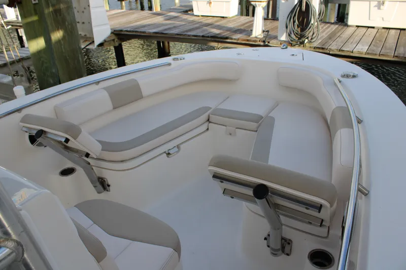 Slide: The Image of 2017 Robalo R200 Center Console boat with cushioned seating at dock. - 2