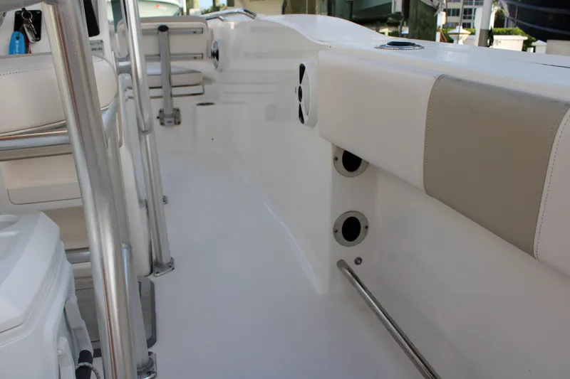 Slide: The Image of 2017 Robalo R200 Center Console boat interior with white seating and stainless steel fixtures. - 27