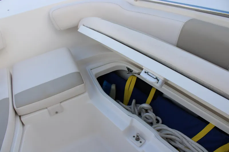 Slide: The Image of 2017 Robalo R200 Center Console boat storage compartment with ropes and gear. - 30