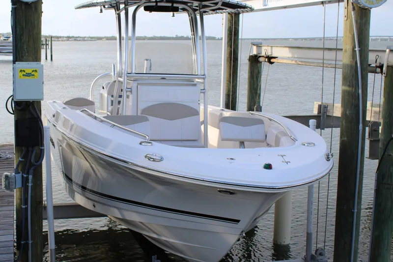 Slide: The Image of 2017 Robalo R200 Center Console boat docked on a lift by the water. - 33