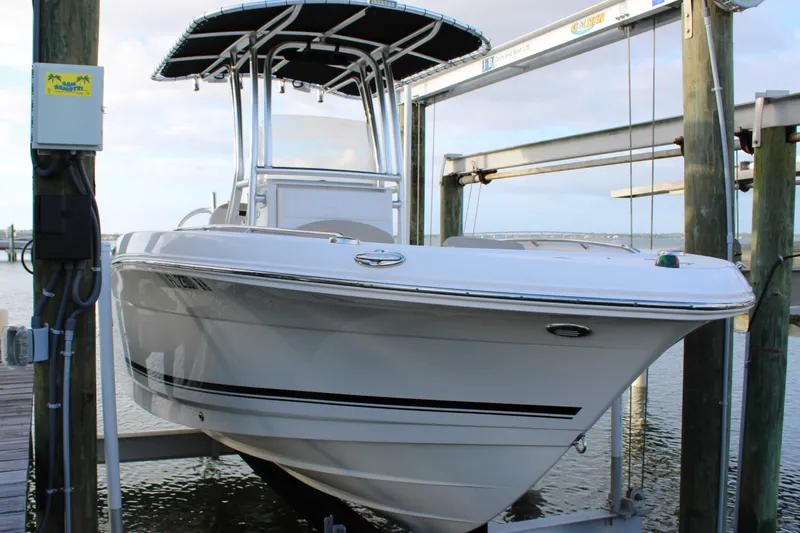 Slide: The Image of 2017 Robalo R200 Center Console boat on lift at marina dock. - 34