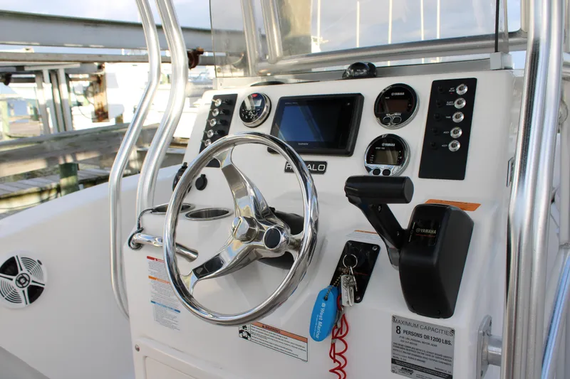 Slide: The Image of 2017 Robalo R200 Center Console boat dashboard with steering wheel and controls. - 9