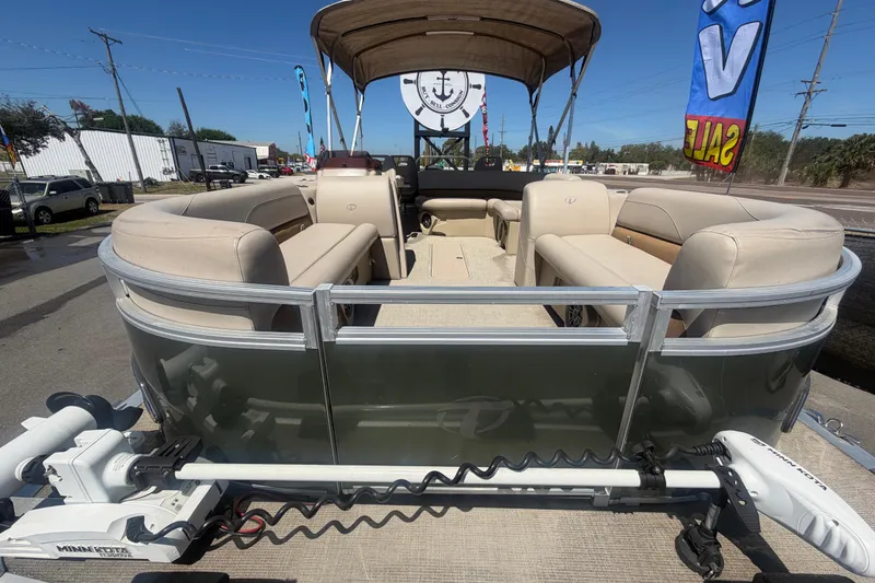 Slide: The Image of 2023 Tahoe Pontoon GT 2385 RF with beige interior, sale signs in background. - 18