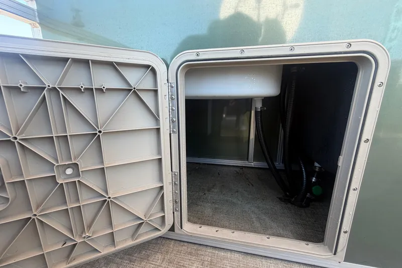 Slide: The Image of Open storage compartment in Tahoe Pontoon GT 2385 RF 2023. - 31