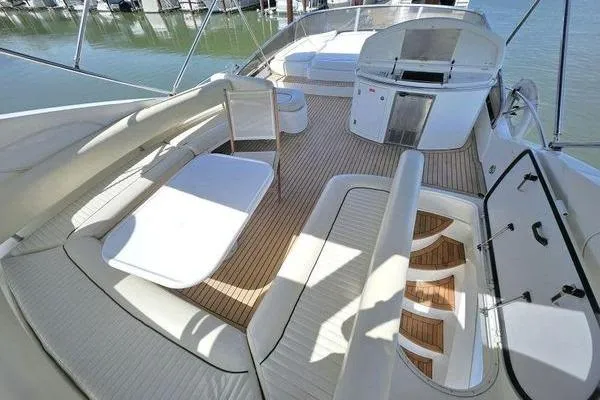 Slide: The Image of Luxurious 2005 Sunseeker Manhattan 66 yacht deck with seating and dining area. - 10