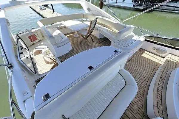 Slide: The Image of Luxurious 2005 Sunseeker Manhattan 66 yacht with spacious deck and elegant seating. - 13