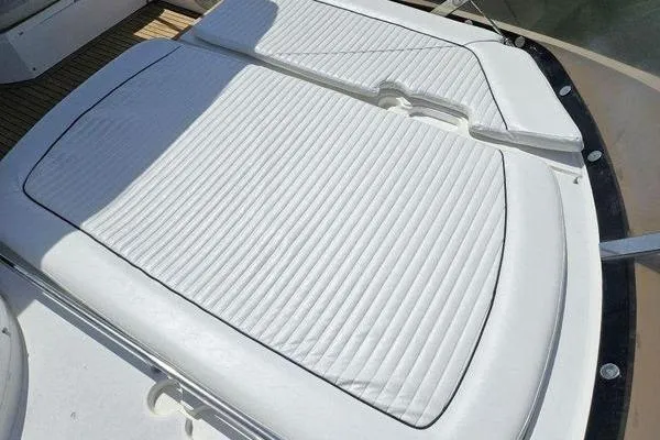 Slide: The Image of Sunseeker Manhattan 66 (2005) yacht sunpad with white cushioned seating. - 14