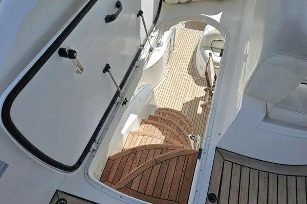 Slide: The Image of Interior view of 2005 Sunseeker Manhattan 66 yacht with wooden stairs and seating area. - 17
