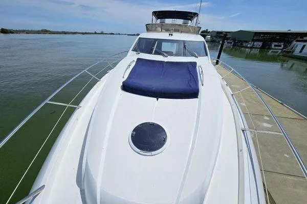 Slide: The Image of 2005 Sunseeker Manhattan 66 yacht docked, featuring sleek design and spacious deck. - 19