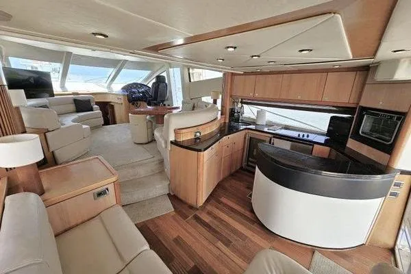 Slide: The Image of Luxurious interior of a 2005 Sunseeker Manhattan 66 yacht with modern kitchen and seating area. - 24