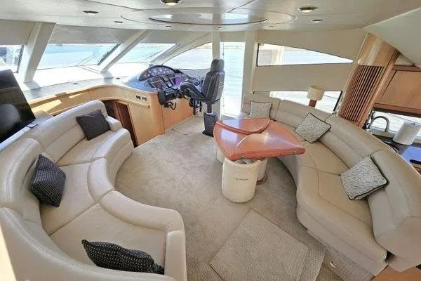 Slide: The Image of Luxurious interior of a 2005 Sunseeker Manhattan 66 yacht with plush seating and helm. - 27