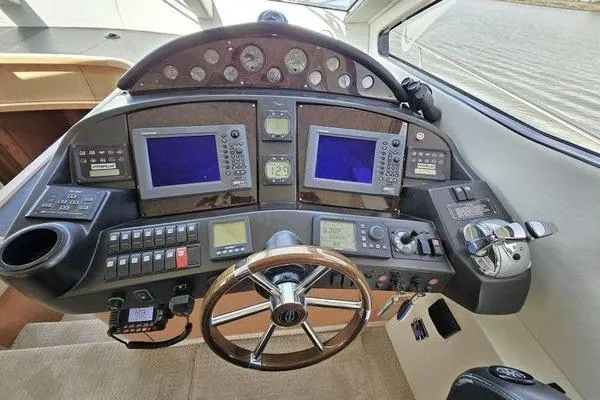 Slide: The Image of Cockpit of 2005 Sunseeker Manhattan 66 yacht with navigation controls and steering wheel. - 31