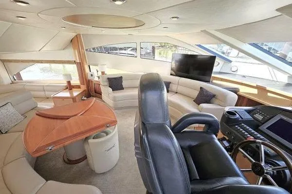 Slide: The Image of Luxurious interior of a 2005 Sunseeker Manhattan 66 yacht with plush seating and modern helm. - 34