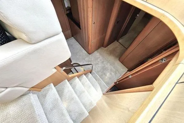 Slide: The Image of Interior view of 2005 Sunseeker Manhattan 66 yacht, featuring carpeted stairs and wooden paneling. - 36