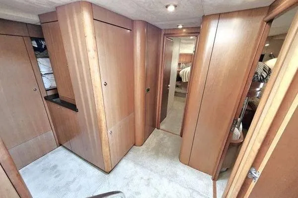 Slide: The Image of Interior of 2005 Sunseeker Manhattan 66 yacht, featuring wooden cabinetry and carpeted flooring. - 37