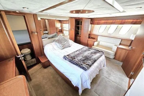 Slide: The Image of Luxurious bedroom interior of 2005 Sunseeker Manhattan 66 yacht with elegant wood finishes. - 38
