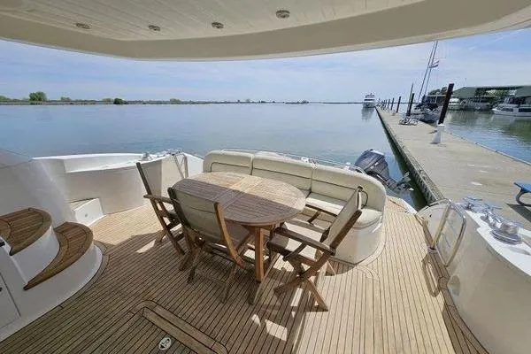 Slide: The Image of Luxurious 2005 Sunseeker Manhattan 66 yacht deck with seating and scenic waterfront view. - 5