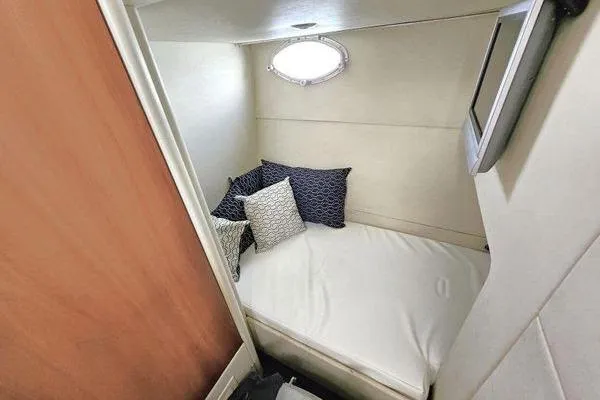Slide: The Image of Cozy cabin interior of 2005 Sunseeker Manhattan 66 yacht with bed and pillows. - 63