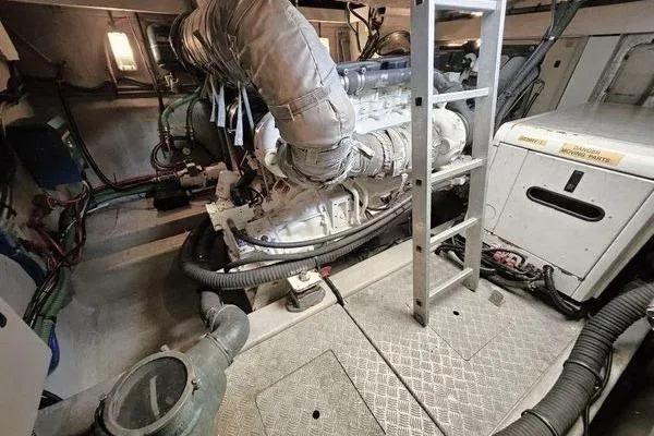 Slide: The Image of Engine room of a 2005 Sunseeker Manhattan 66 yacht, featuring machinery and ladder. - 67