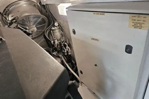 Slide: The Image of Engine room of a 2005 Sunseeker Manhattan 66 yacht, featuring electrical components and ventilation. - 72