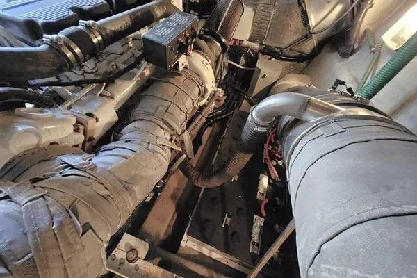 Slide: The Image of Engine room of a 2005 Sunseeker Manhattan 66 yacht, showcasing mechanical components. - 75