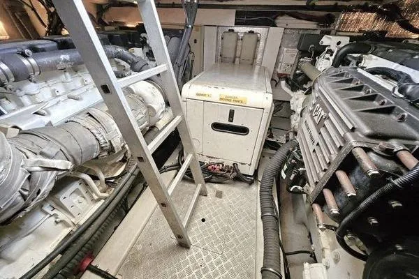 Slide: The Image of Engine room of 2005 Sunseeker Manhattan 66 yacht with visible machinery and ladder. - 76