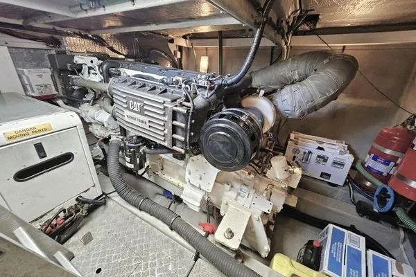 Slide: The Image of Engine room of a 2005 Sunseeker Manhattan 66 yacht, featuring a CAT marine engine. - 78