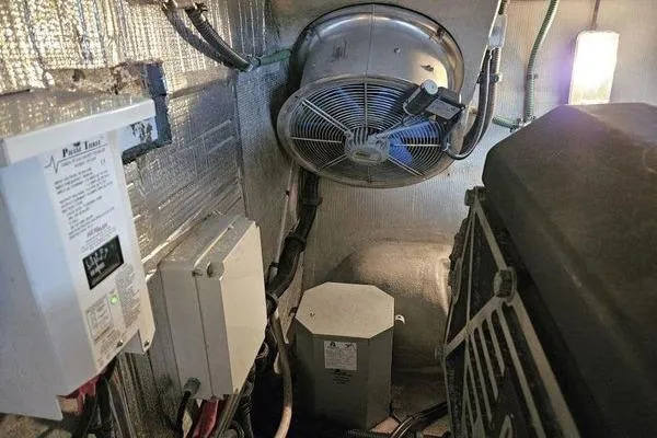 Slide: The Image of Engine room of a 2005 Sunseeker Manhattan 66 yacht, featuring electrical components and ventilation. - 80