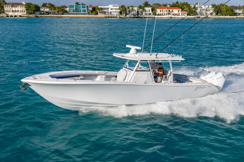 The Image of 2024 Yellowfin 39 Offshore boat cruising on blue water near coastal homes. - 0