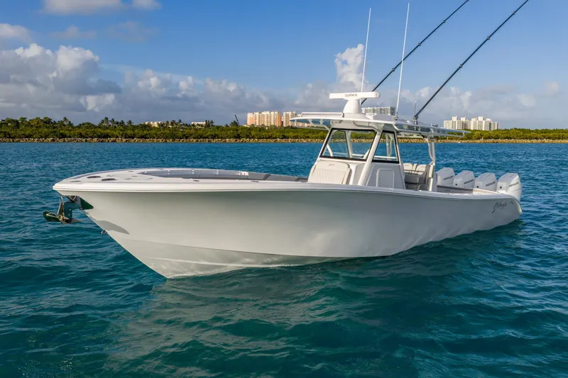 Slide: The Image of 2024 Yellowfin 39 Offshore boat on blue ocean with clear sky background. - 10