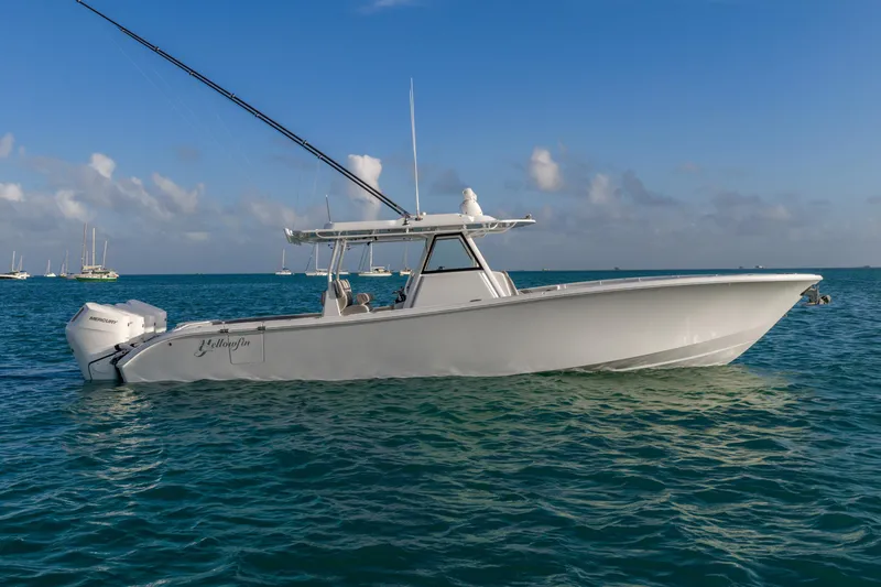 Slide: The Image of 2024 Yellowfin 39 Offshore boat on calm ocean waters under a clear blue sky. - 12