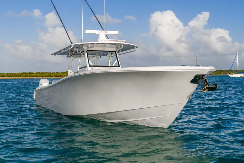 Slide: The Image of 2024 Yellowfin 39 Offshore boat on calm blue water under a partly cloudy sky. - 13